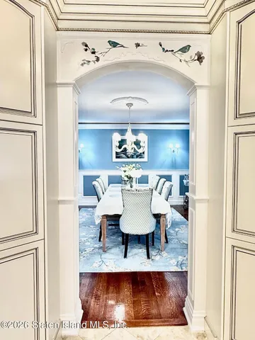 a view of a dining room with furniture and chandelier