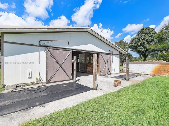 a view of a backyard with table and chairs