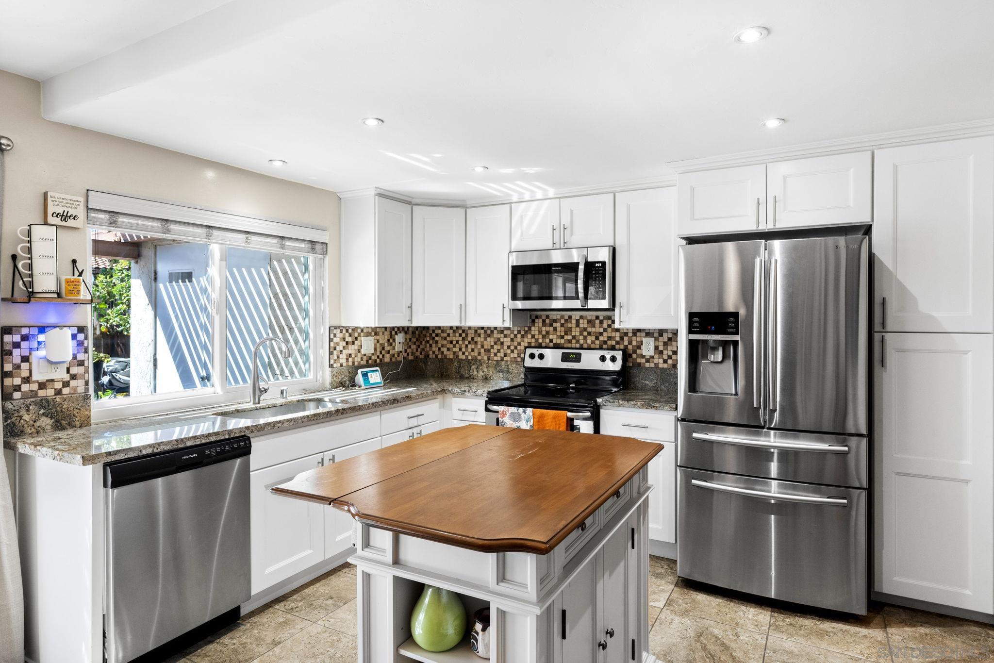 1651 South Juniper Street, Unit 270 Escondido, CA 92025 - Photo 1 of 48 a kitchen with kitchen island a refrigerator stove microwave and sink