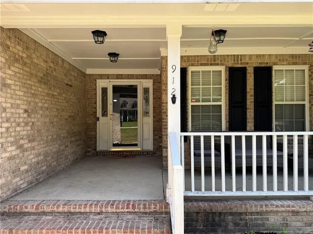 a view of a porch with a table and chair
