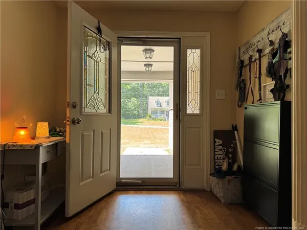 a view of a room with wooden floor and windows