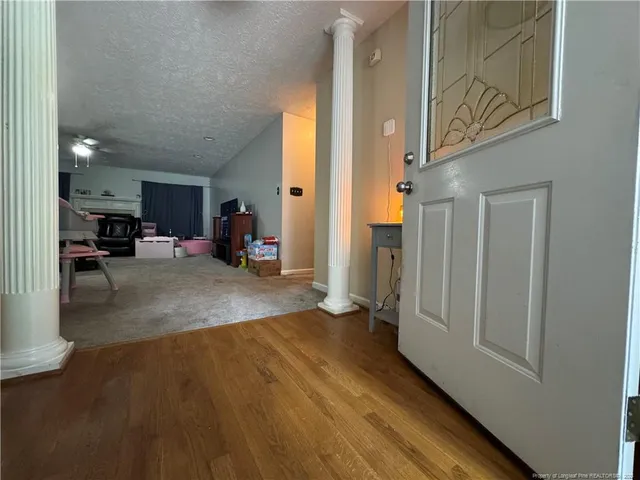 a view of a livingroom with couch and white cabinets
