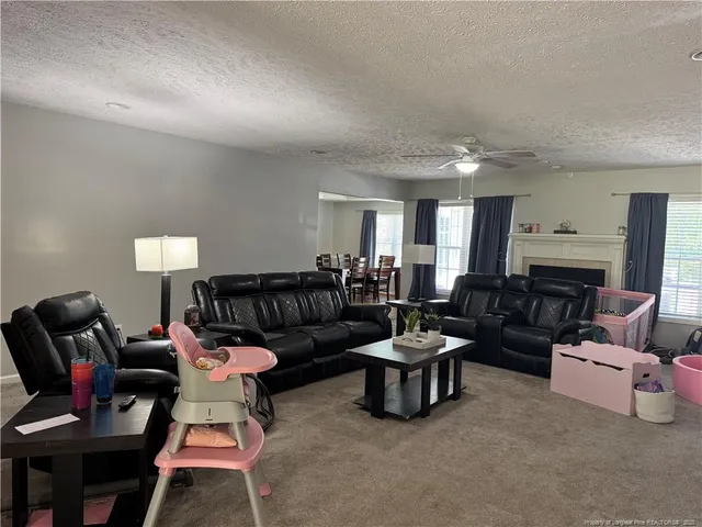 a living room with furniture and a lamp