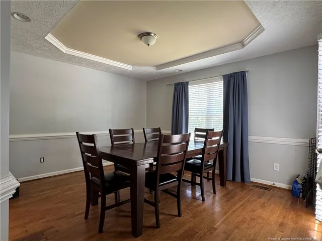 a view of a dining room with furniture and wooden floor