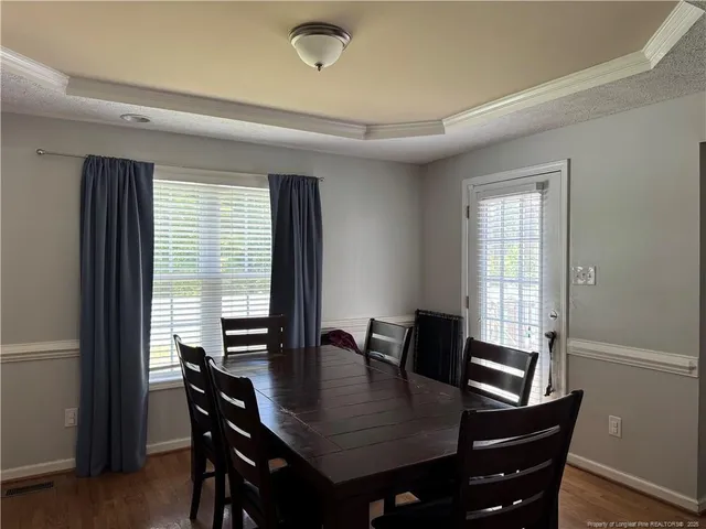 a view of a dining room with furniture and window