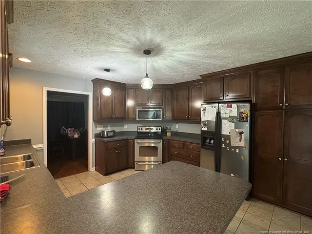 a large kitchen with cabinets and stainless steel appliances