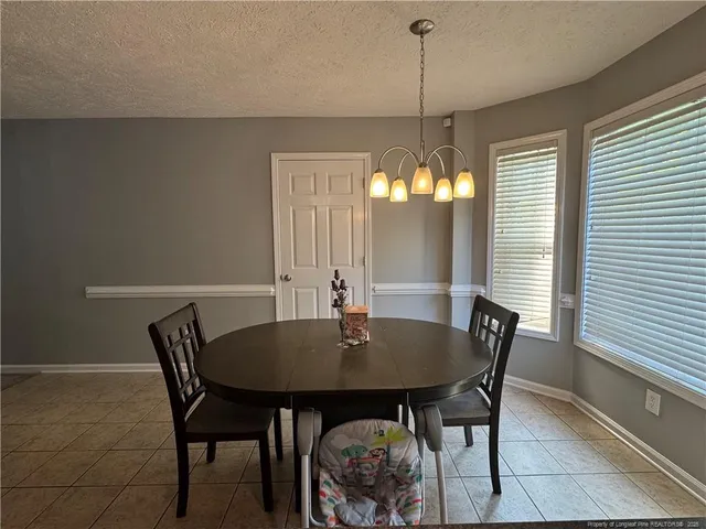 a view of a dining room with furniture and window