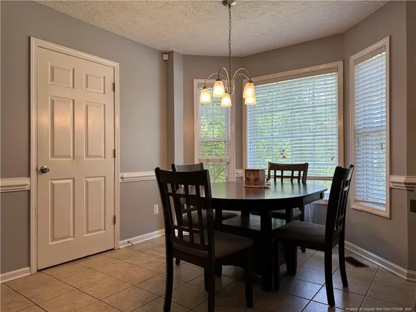 a view of a dining room with furniture window and outside view