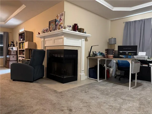 a living room with furniture a fireplace and a flat screen tv