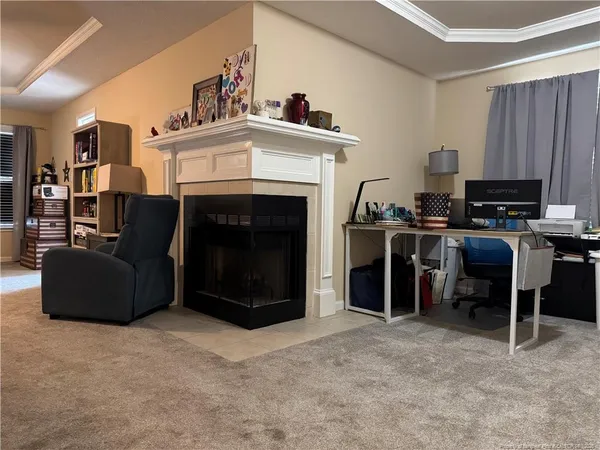a living room with furniture a fireplace and a flat screen tv