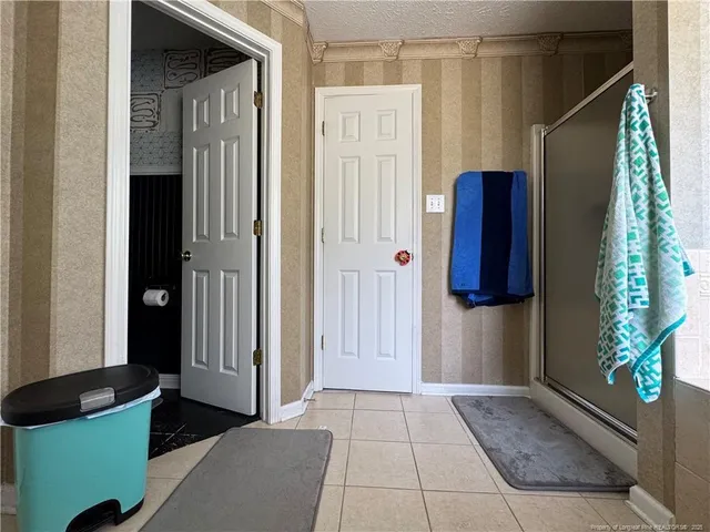 a view of walk in closet with wooden floor