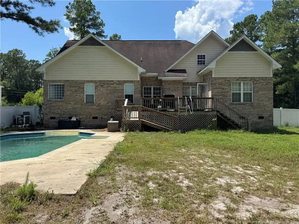 a front view of a house with a garden and yard
