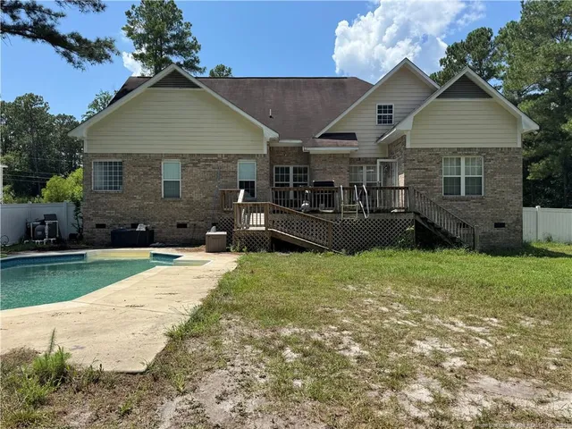 a front view of a house with a garden and yard