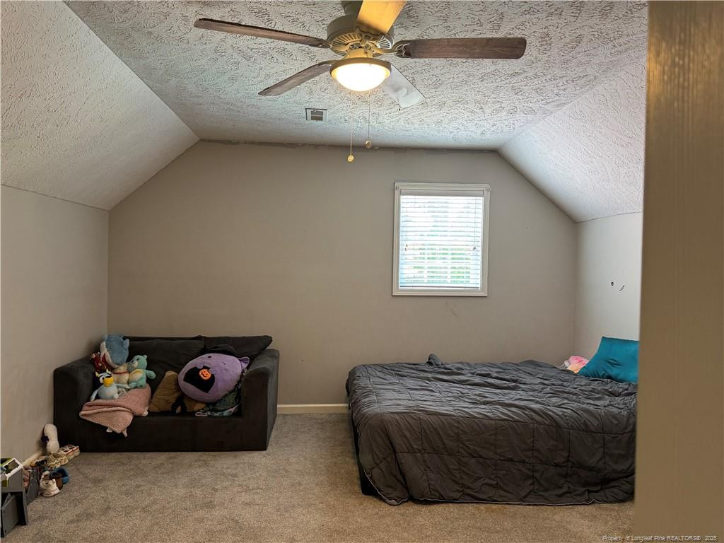 912 Lewis Street Raeford, NC 28376 - Photo 41 of 45 a bedroom with a bed and a chandelier