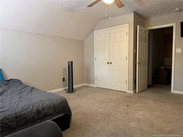 a bedroom with a bed and a walk in closet