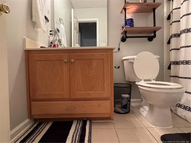 a bathroom with a toilet and a mirror