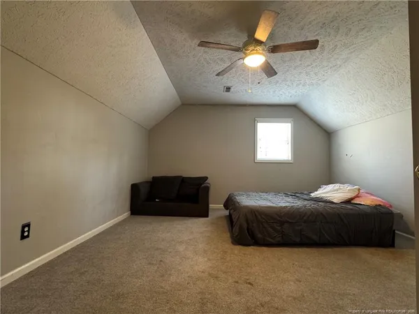 a bedroom with a bed and a ceiling fan