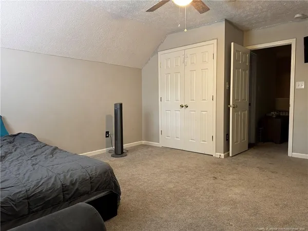 a bedroom with a bed and a walk in closet