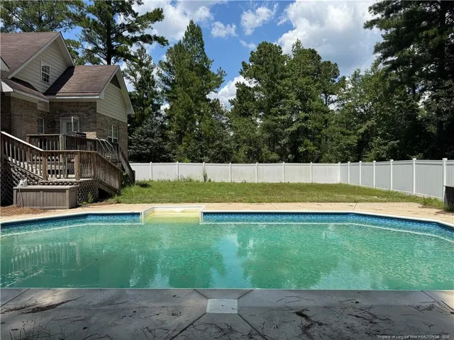 a view of swimming pool with an outdoor space and seating area