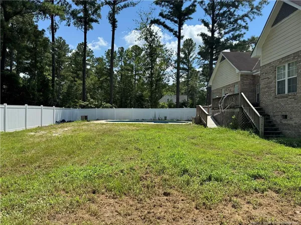 a view of a backyard with a tree