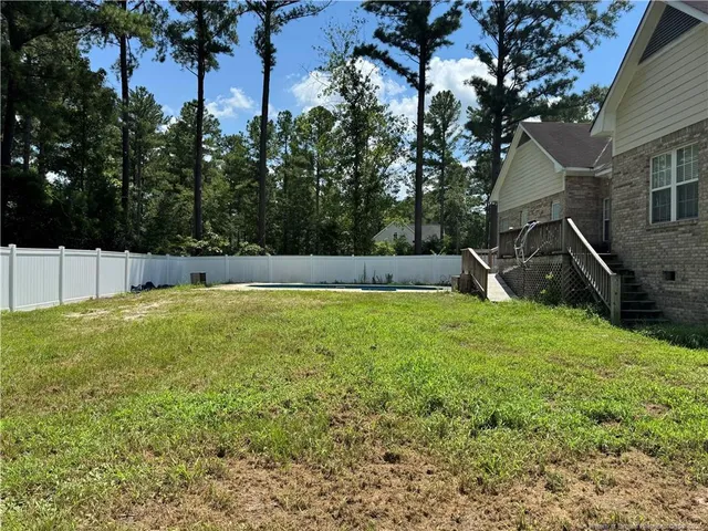 a view of a backyard with a tree