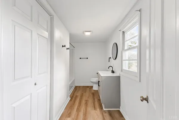 a view of a bathroom with a sink cabinet and mirror