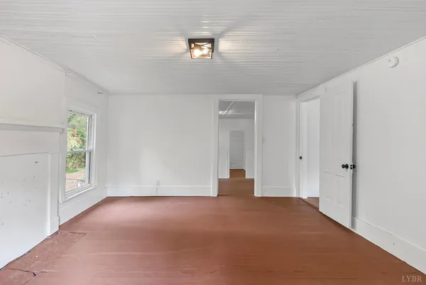 an empty room with windows and closet