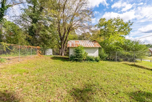 a view of a backyard with large trees