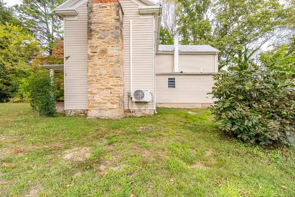 a backyard of a house with lots of green space and lake view