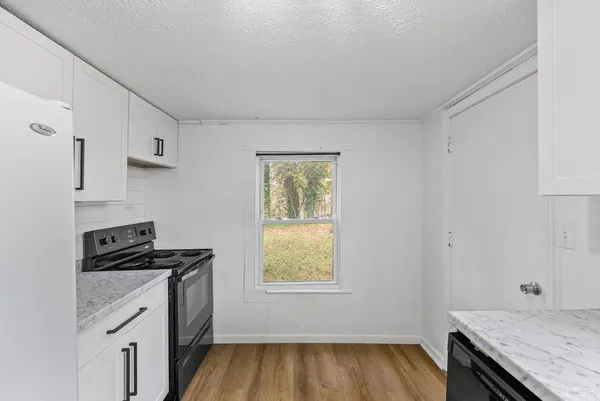 a kitchen with wooden cabinets and a stove