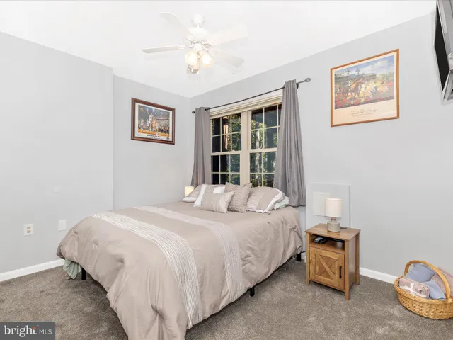 an aerial view of residential house with outdoor space and trees all around