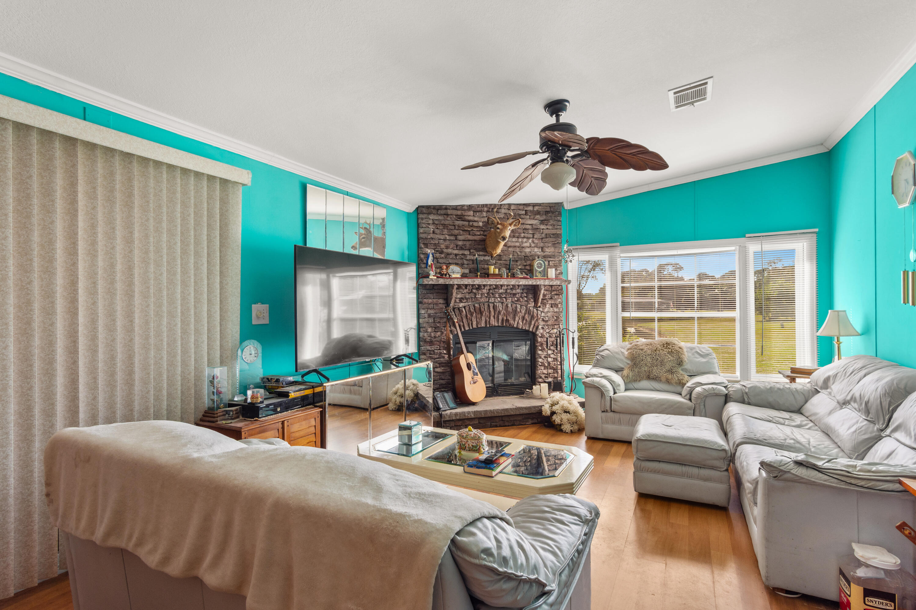 18 Nuevo Leon Road Port St. Lucie, FL 34952 - Photo 11 of 36 a living room with furniture and a fireplace