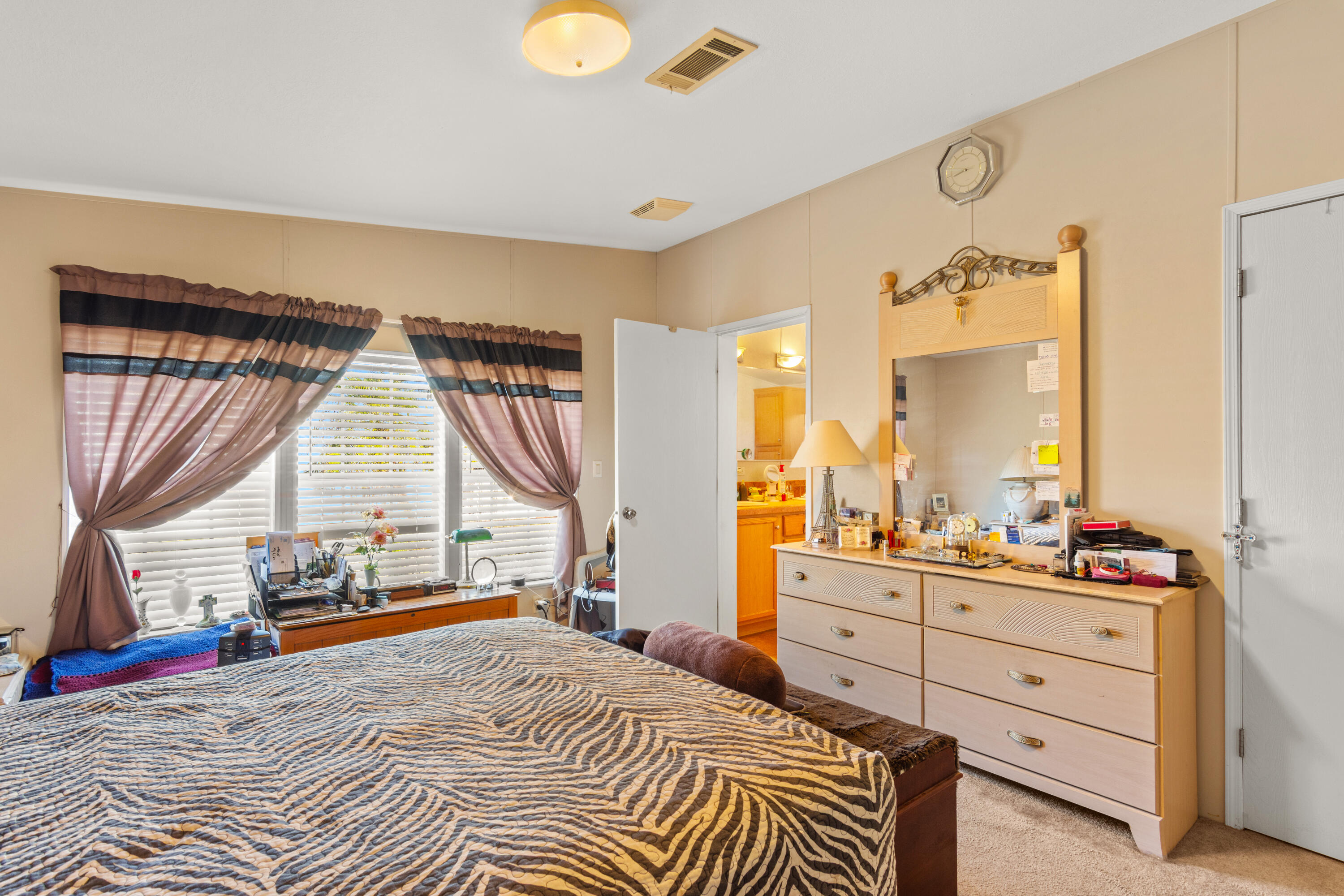 18 Nuevo Leon Road Port St. Lucie, FL 34952 - Photo 15 of 36 a bedroom with a bed a large window and flat screen tv