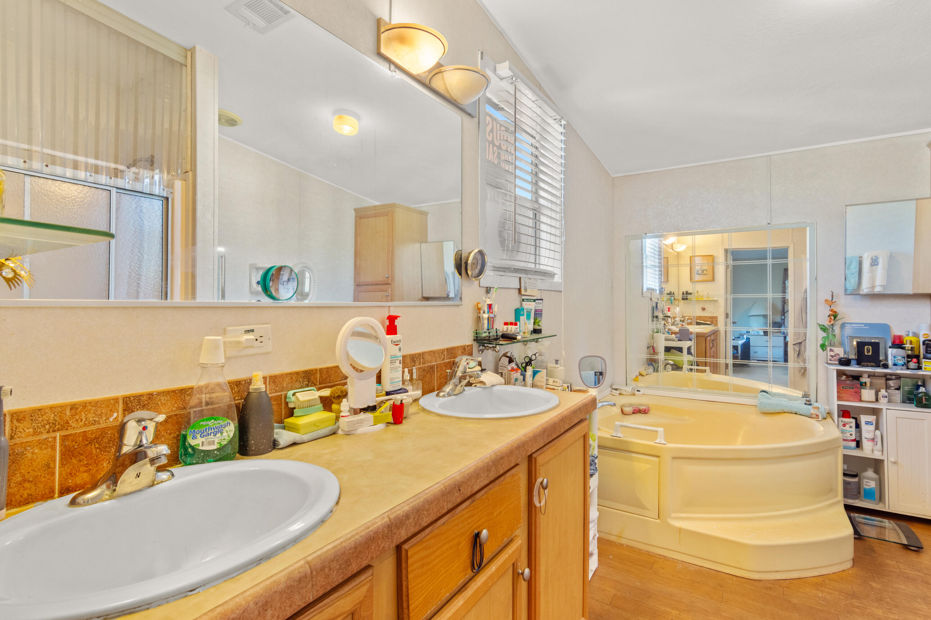 18 Nuevo Leon Road Port St. Lucie, FL 34952 - Photo 16 of 36 a bathroom with a tub sink and mirror