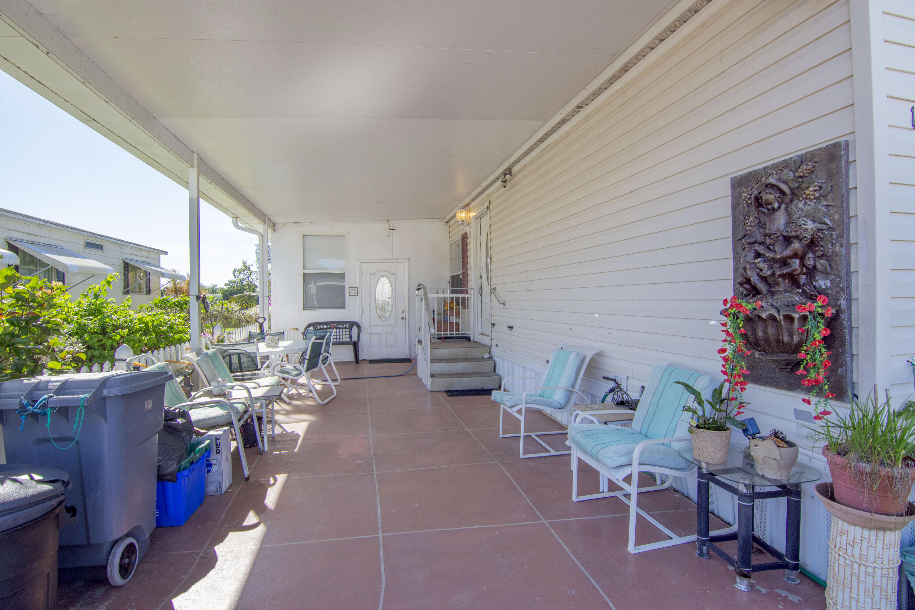 18 Nuevo Leon Road Port St. Lucie, FL 34952 - Photo 23 of 36 a living room with patio furniture and a potted plant