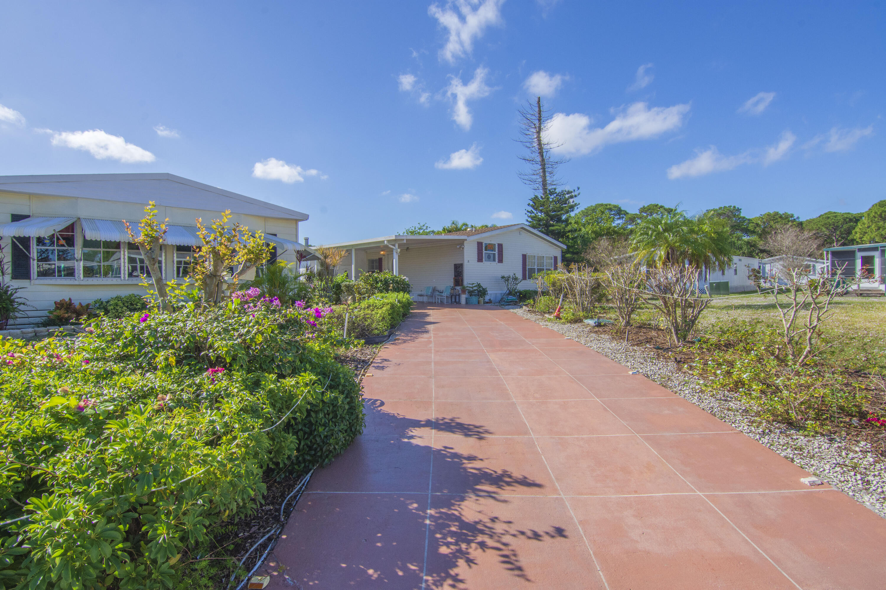 18 Nuevo Leon Road Port St. Lucie, FL 34952 - Photo 24 of 36 a front view of a house with a yard and lake view