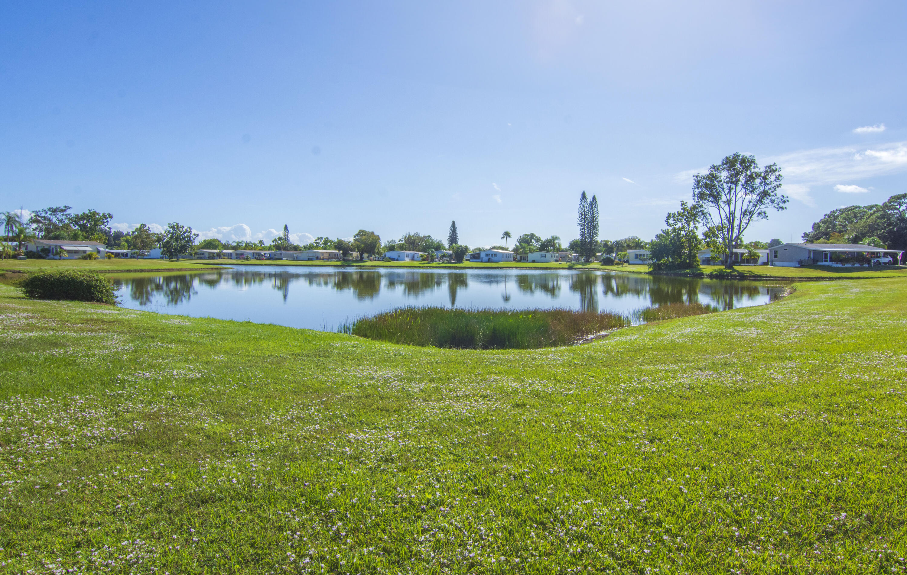 18 Nuevo Leon Road Port St. Lucie, FL 34952 - Photo 28 of 36 a view of a lake with houses in the back
