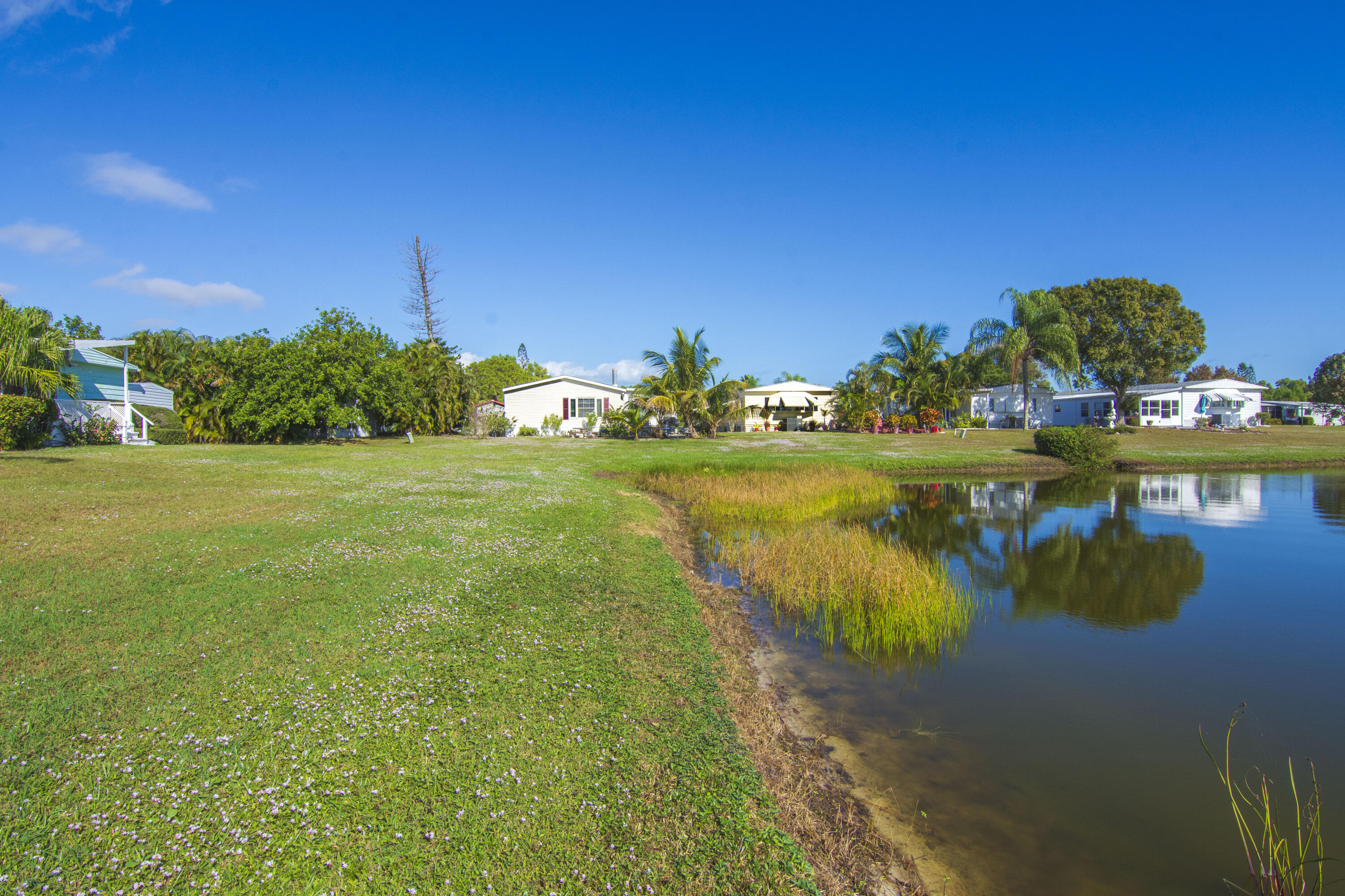 18 Nuevo Leon Road Port St. Lucie, FL 34952 - Photo 30 of 36 a view of a lake with houses in the back