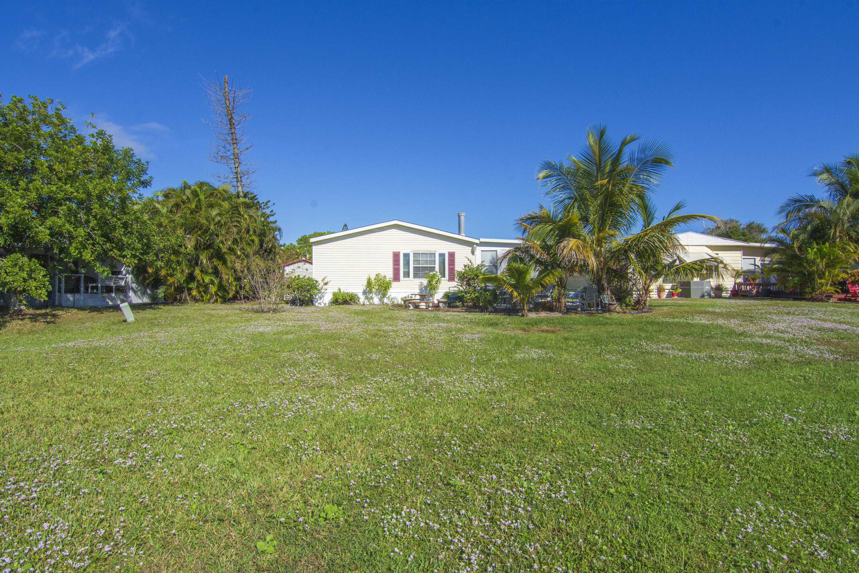 18 Nuevo Leon Road Port St. Lucie, FL 34952 - Photo 31 of 36 a view of an house with backyard space and garden