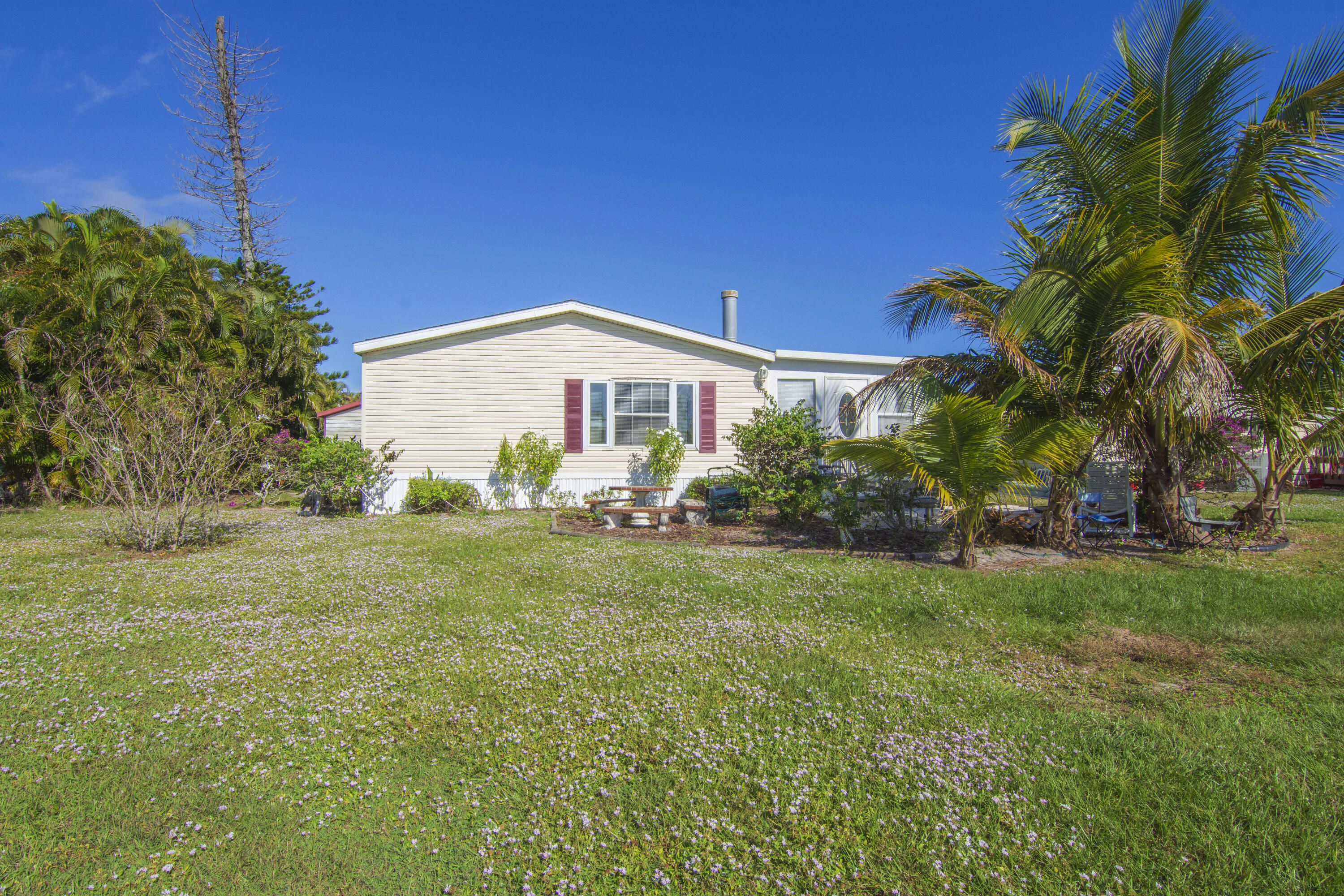 18 Nuevo Leon Road Port St. Lucie, FL 34952 - Photo 32 of 36 a view of a house with a yard