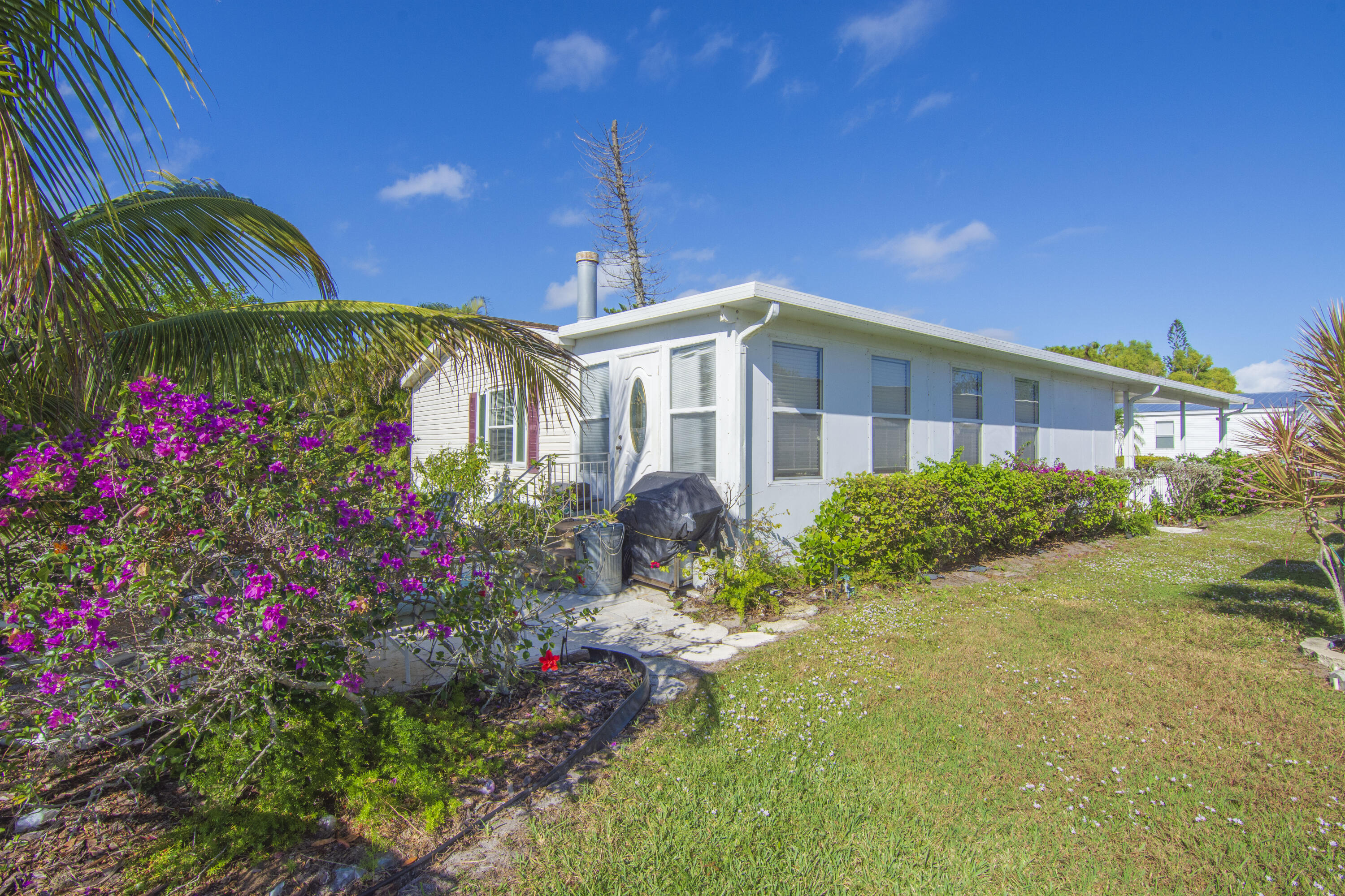 18 Nuevo Leon Road Port St. Lucie, FL 34952 - Photo 34 of 36 a front view of a house with a yard