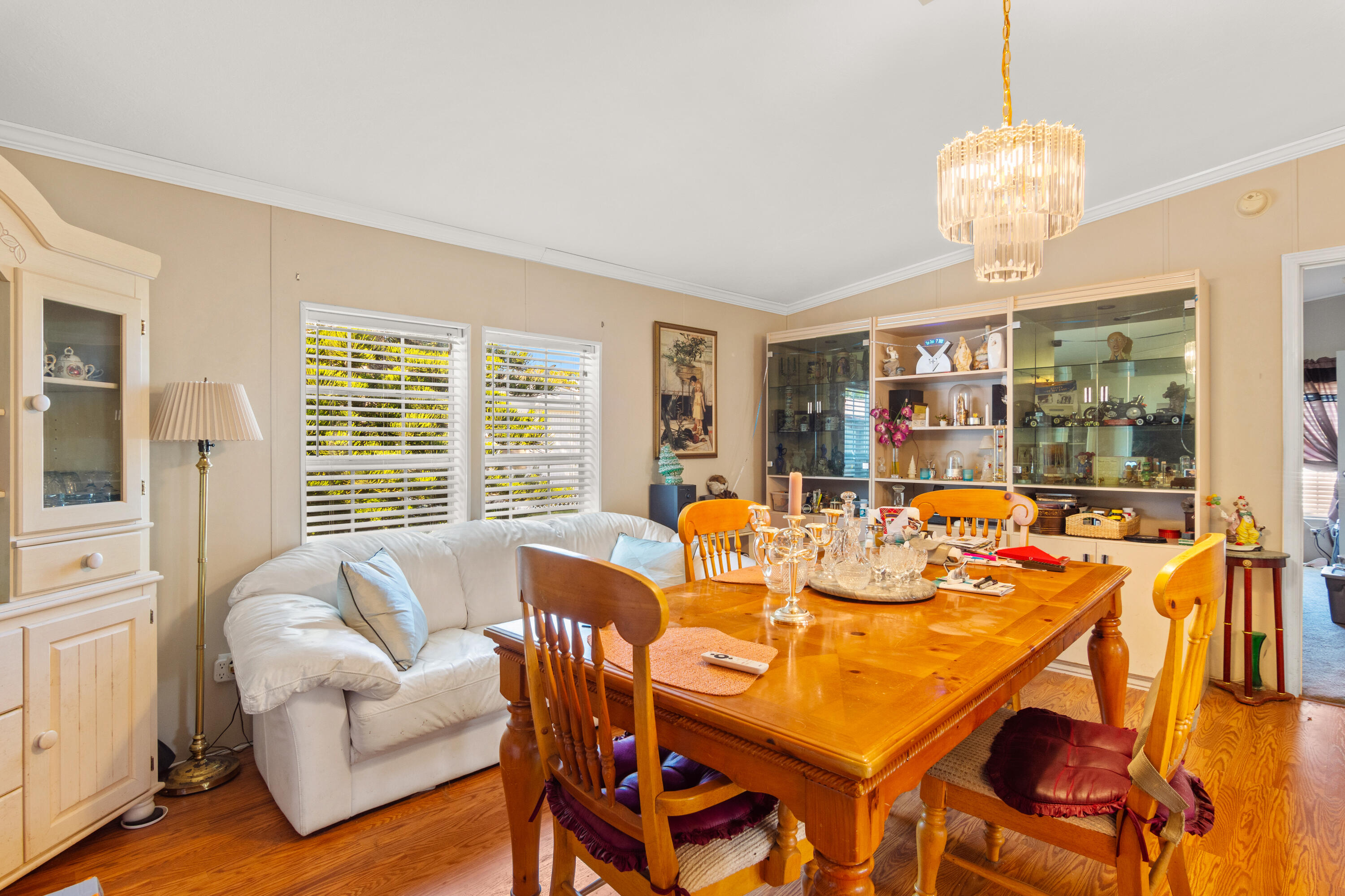 18 Nuevo Leon Road Port St. Lucie, FL 34952 - Photo 6 of 36 a view of a dining room with furniture a chandelier and wooden floor