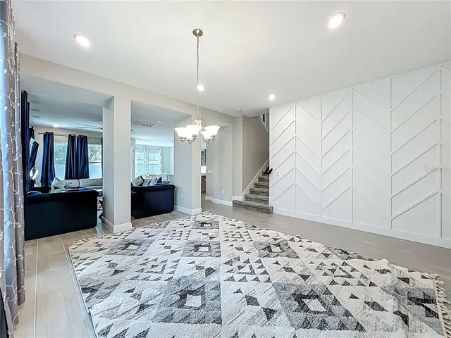 a kitchen with granite countertop a sink and white cabinets