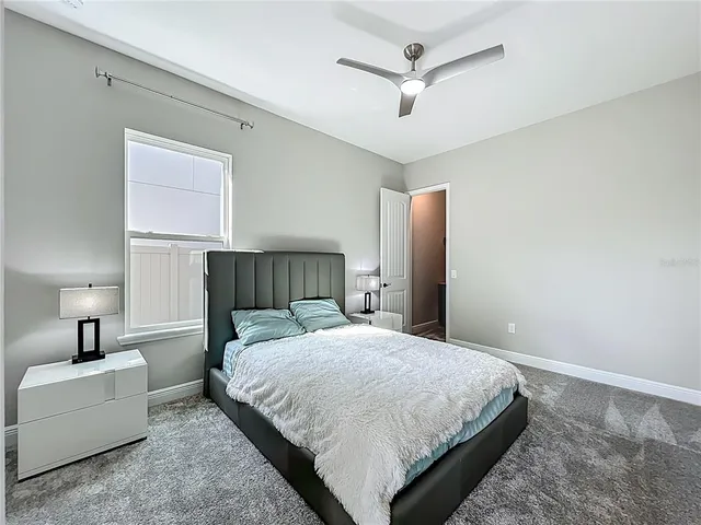 a bedroom with a large bed window and closet