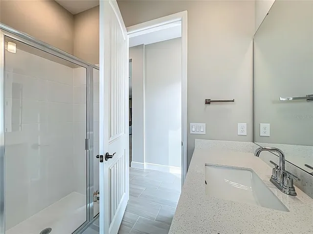 a bathroom with a shower a toilet and sink