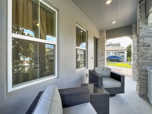 a living room with fireplace furniture and a floor to ceiling window