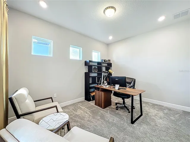 a view of a big room with wooden floor and furniture