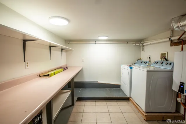 a utility room with cabinets washer and dryer
