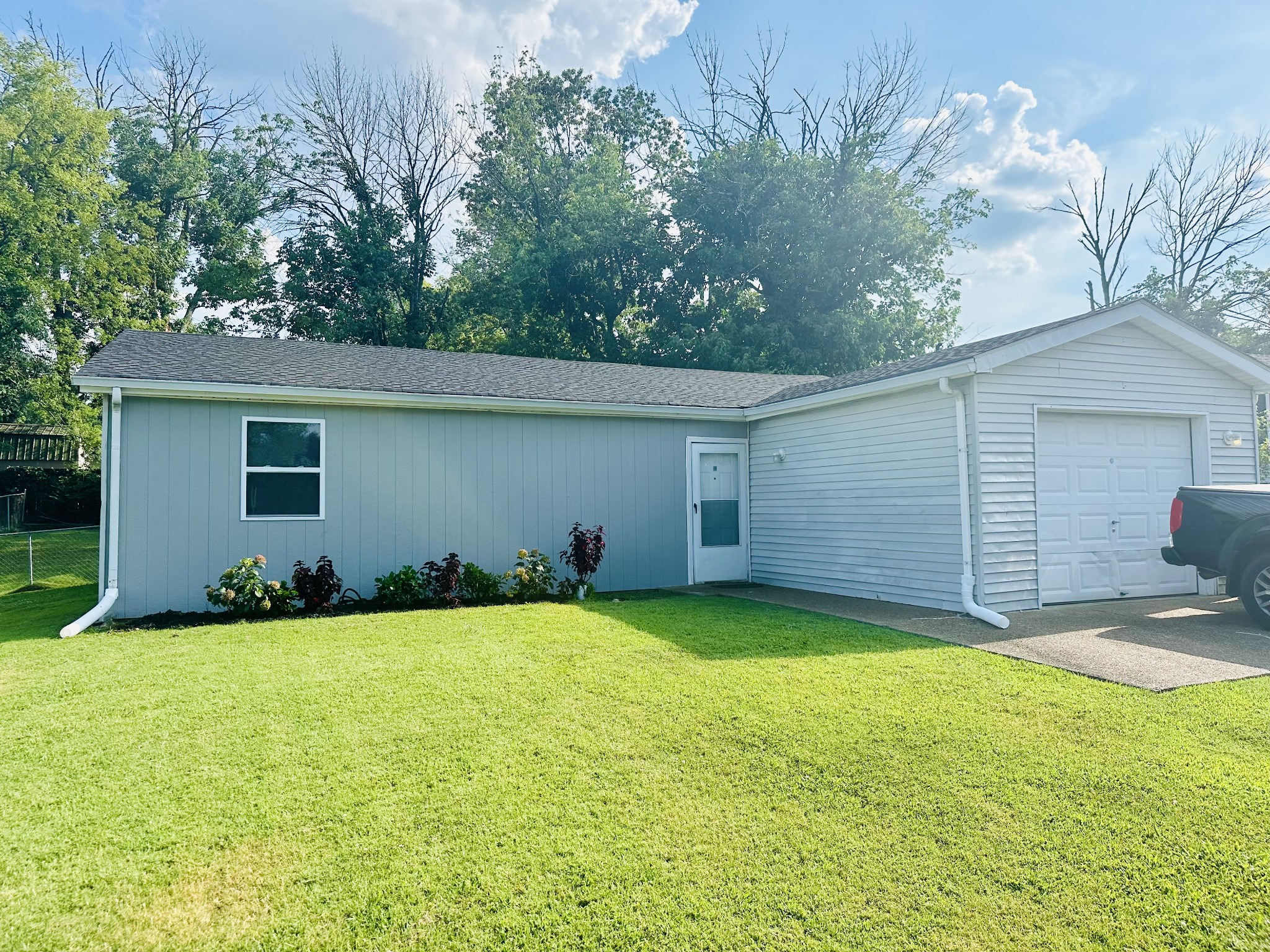 a view of a house with a yard and garage