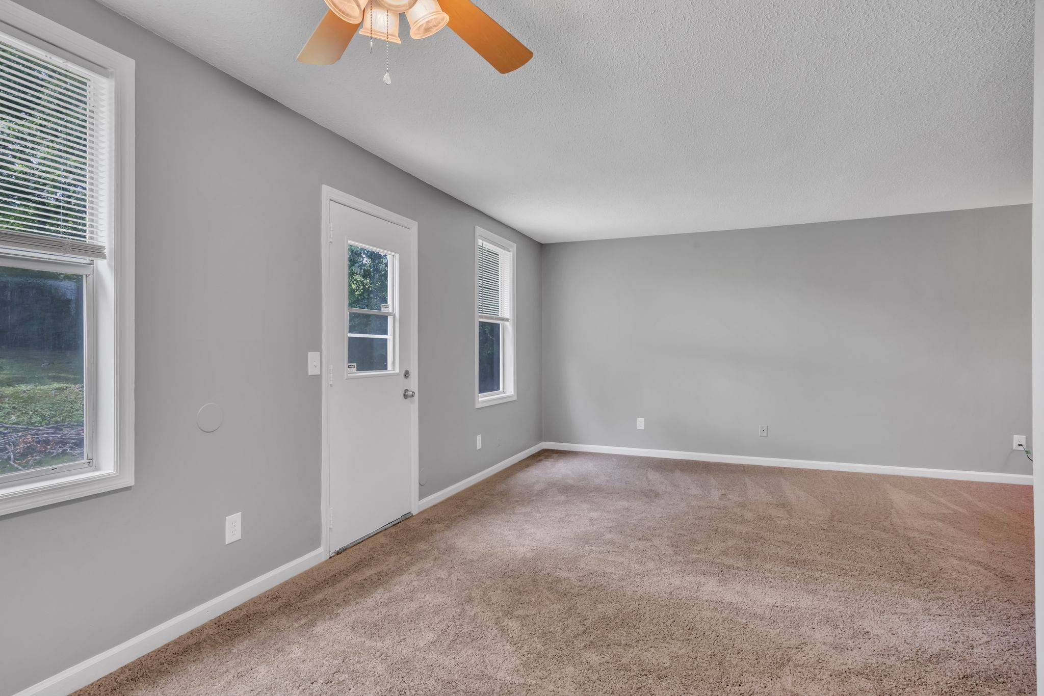 224 Warrior Road Madison, TN 37115 - Photo 11 of 27 an empty room with windows and fan